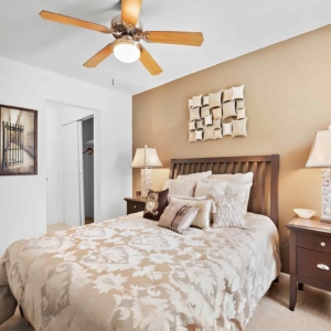 Master bedroom of the model home at Cypress Lake, lots of natural light and a ceiling fan